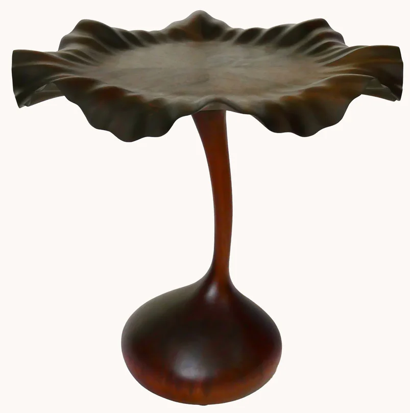 Hanna Flower Petal Table, 2025, walnut and African sapele, 32"height x 32"diameter (onions and knife are not part of the sculpture)